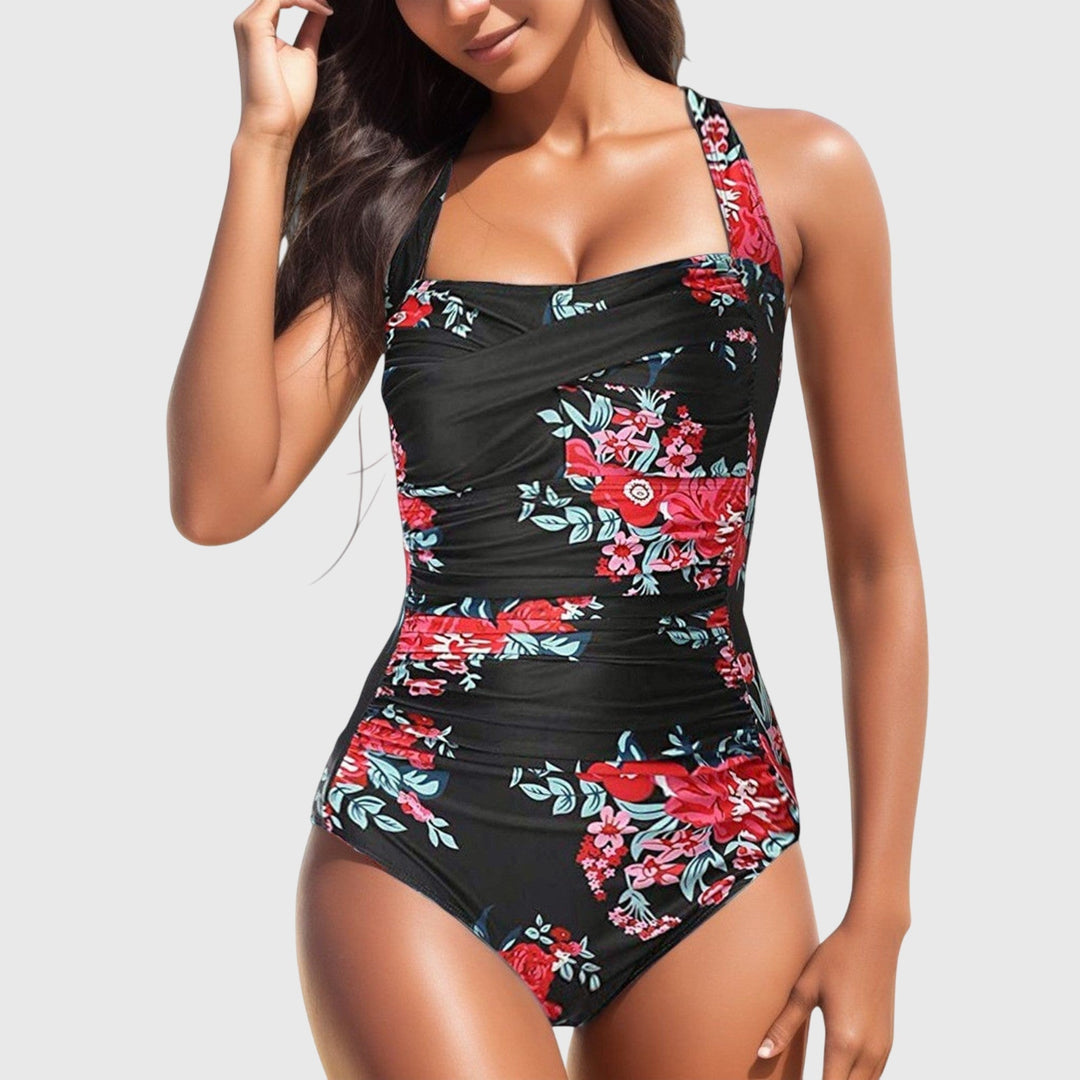 One-piece tummy-smoothing swimsuit, black with red and pink floral print, ruched panel