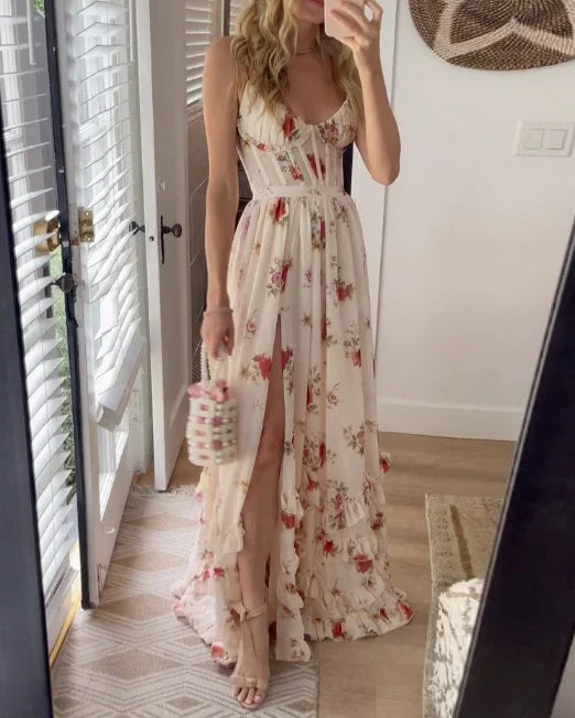 White floral maxi dress with spaghetti straps, deep V bodice, and side slit