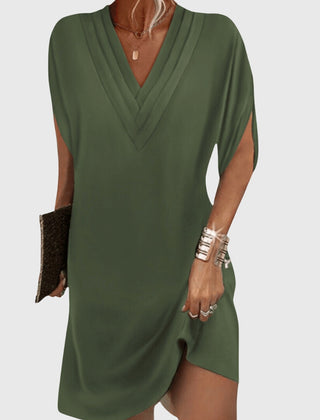 Green draped V-neck dress with short sleeves and wrap-like crossover front