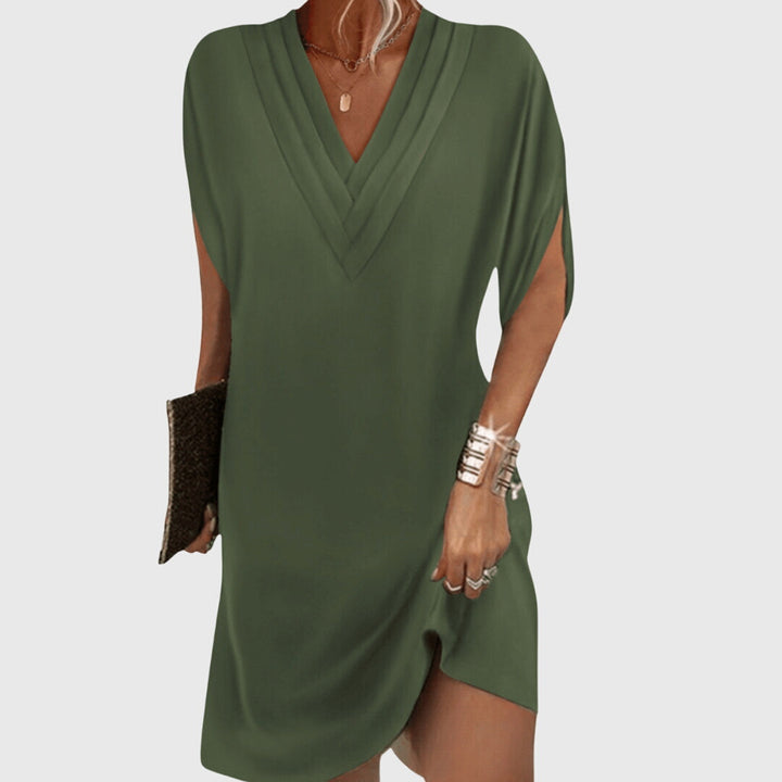 Green draped V-neck dress with short sleeves and wrap-like crossover front