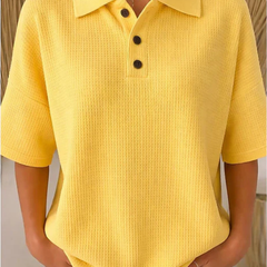 Yellow waffle knit polo blouse with short sleeves, pointed collar, three-button placket