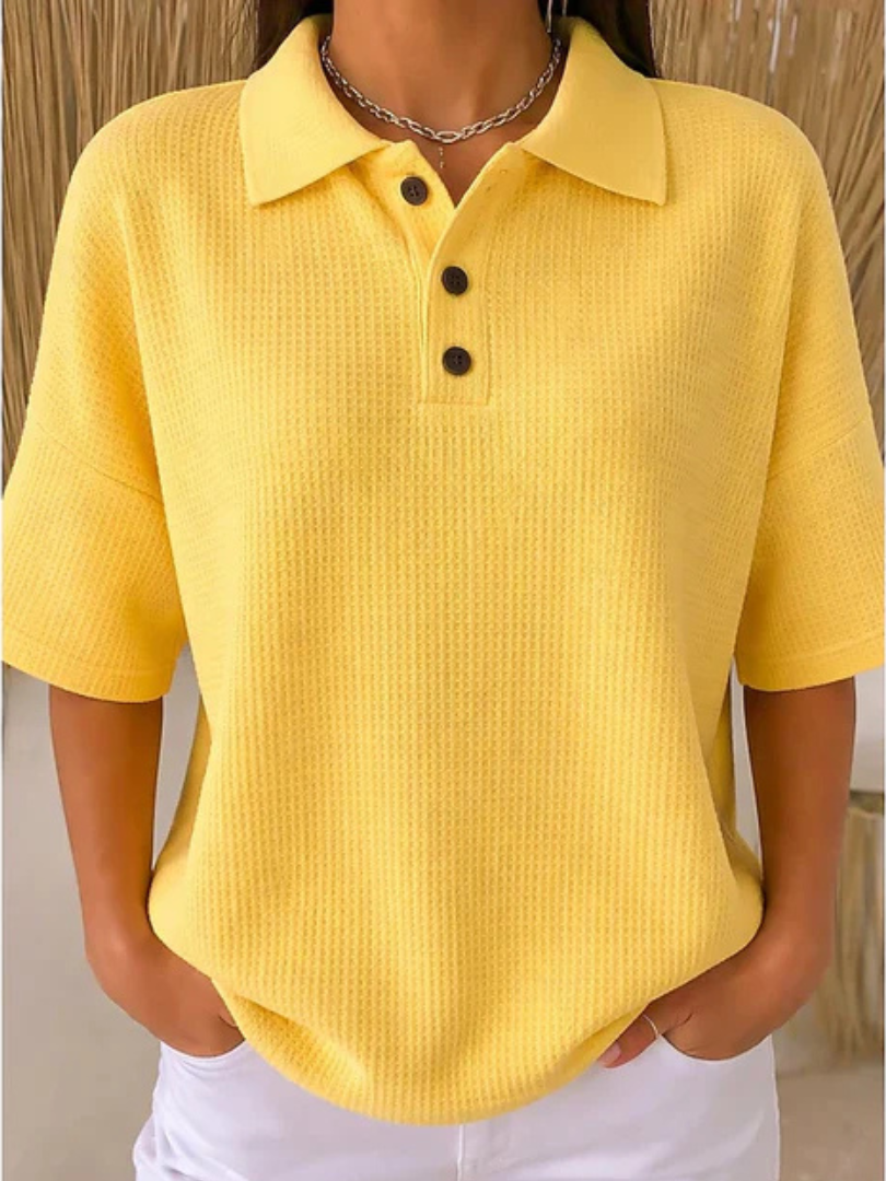 Yellow waffle knit polo blouse with short sleeves, pointed collar, three-button placket