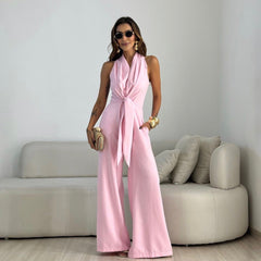 Pink sleeveless jumpsuit with wrap V-neck and tied waist, wide-leg