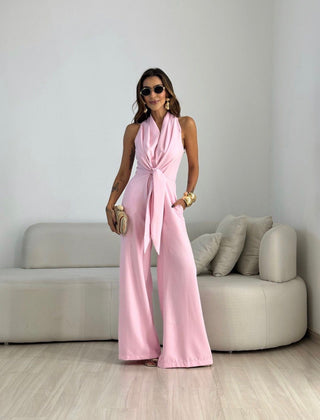 Pink sleeveless jumpsuit with wrap V-neck and tied waist, wide-leg