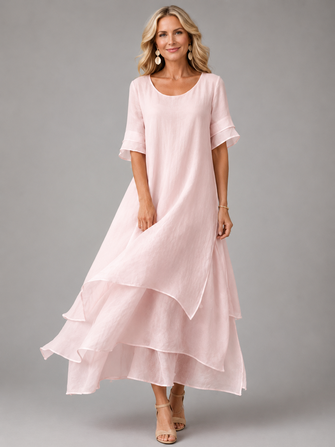 Women's pink tiered maxi dress with short sleeves and layered ruffle hem