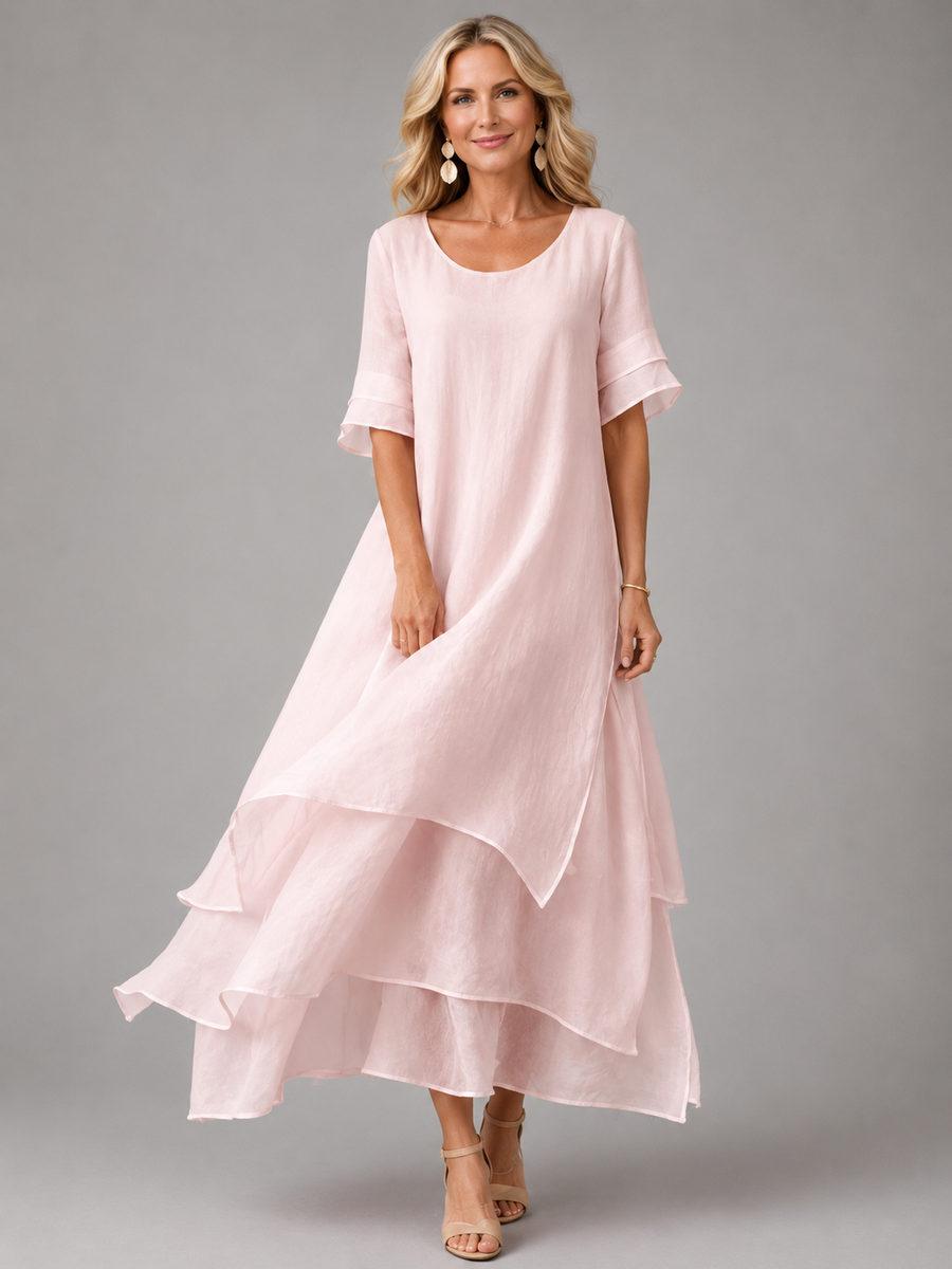 Women's pink tiered maxi dress with short sleeves and layered ruffle hem