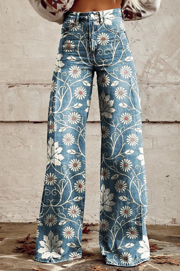 Blue wide-leg vintage jeans with white daisy and vine print, high waist.