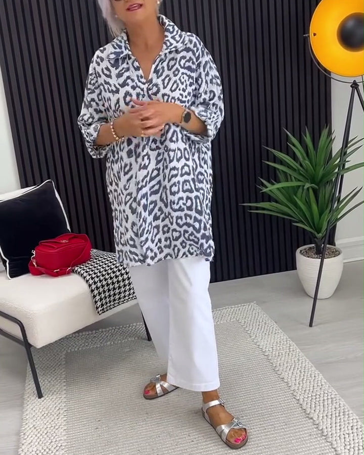 Black-and-white leopard-print collar blouse with 3/4 sleeves and split neckline, tunic hem.