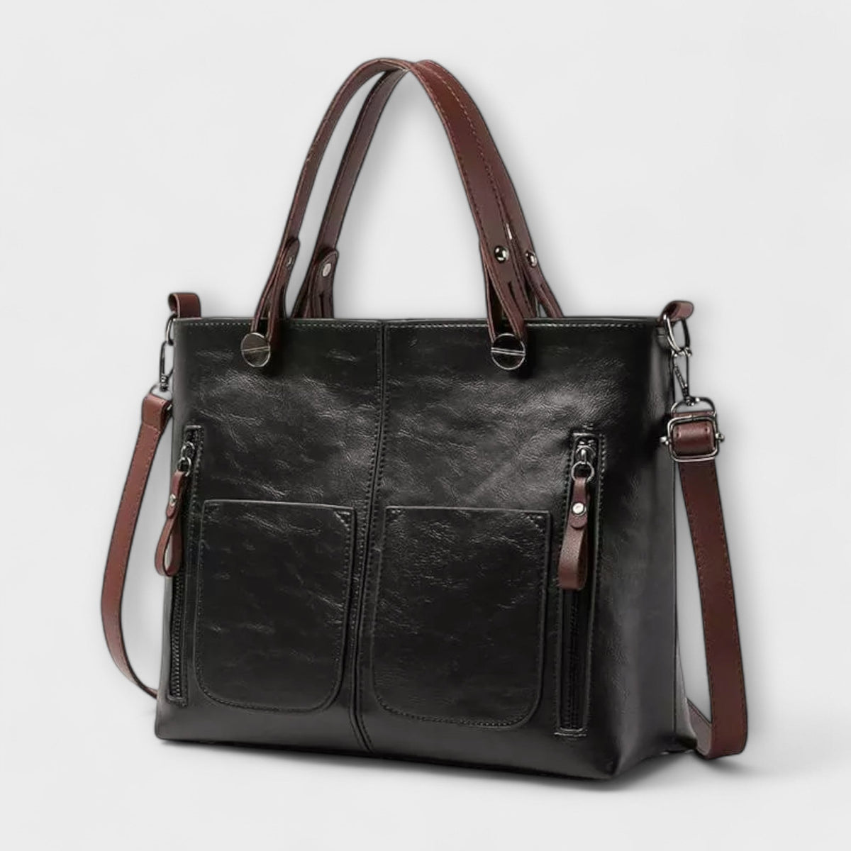 Black leather tote bag with top handles, front zip pockets, and side zip panel.