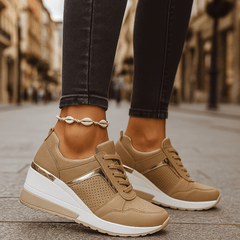Tan lace-up sneakers with perforated toe and thick white sole.