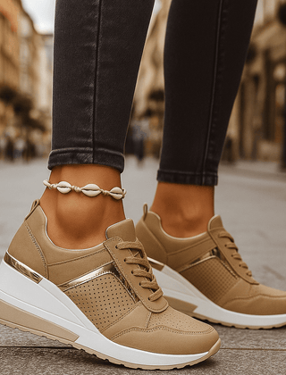 Tan lace-up sneakers with perforated toe and thick white sole.