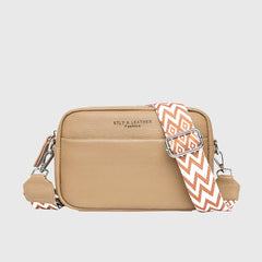 Tan leather shoulder bag with patterned chevron strap and silver-tone zipper pulls