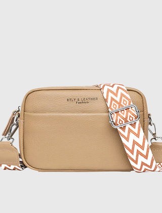 Tan leather shoulder bag with patterned chevron strap and silver-tone zipper pulls