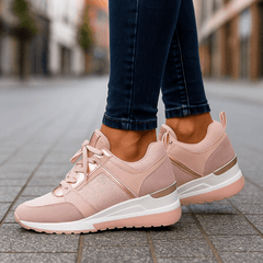 Pink lace-up sneakers with perforated side panel and chunky white sole.