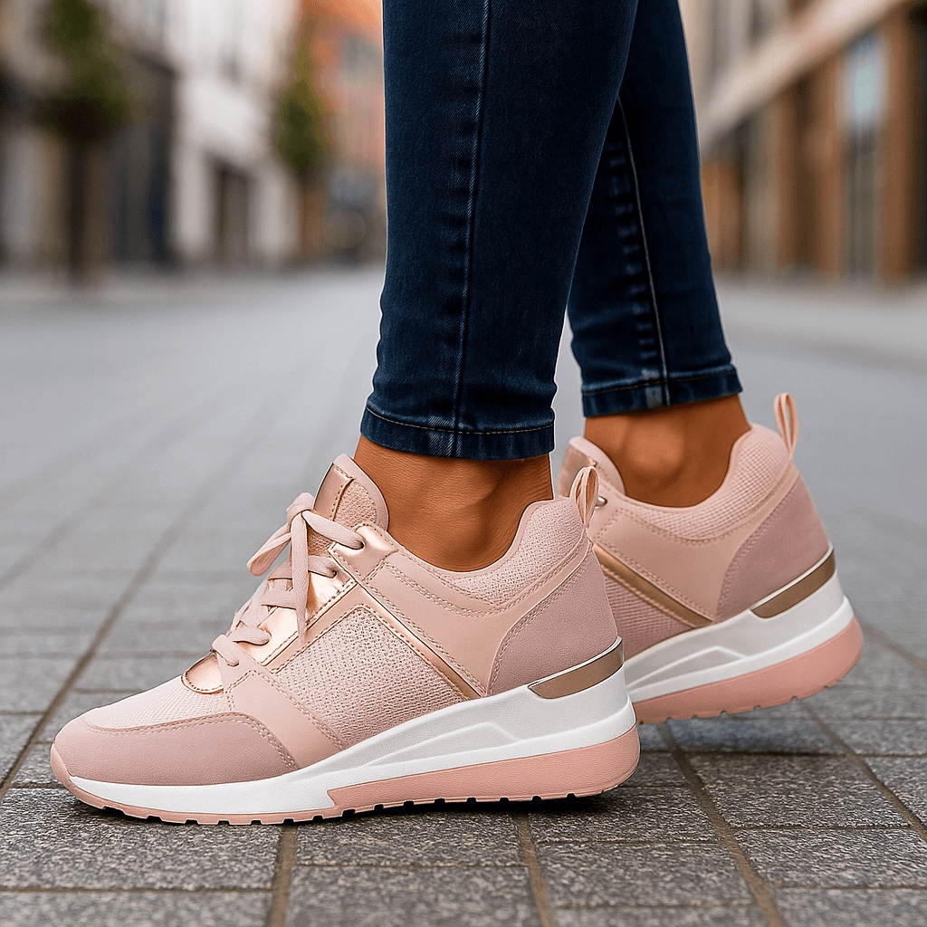 Pink lace-up sneakers with perforated side panel and chunky white sole.