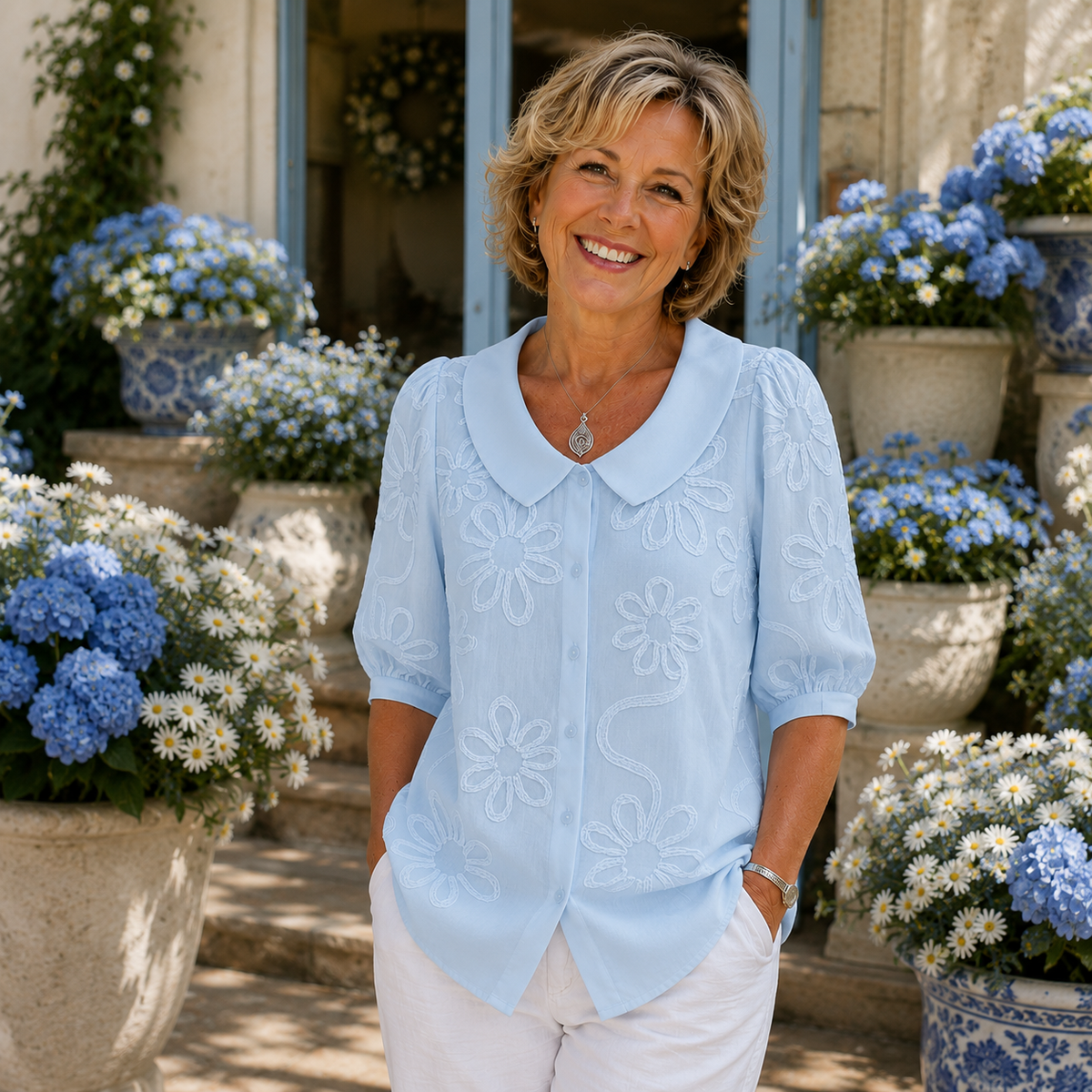 Light blue floral embroidered blouse with round collar and short puff sleeves