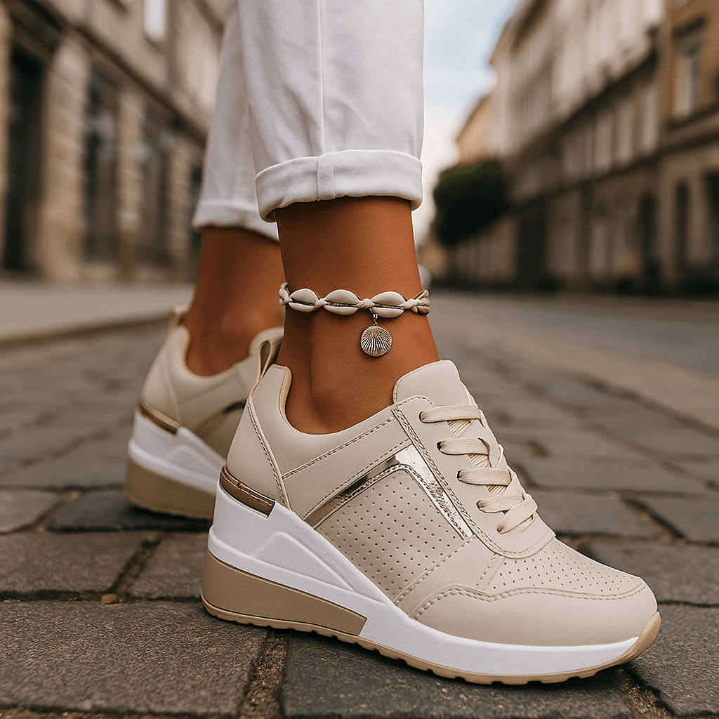 Beige lace-up sneakers with perforated toe and cushioned white sole.
