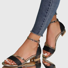 Orthopedic heeled sandals with black glitter straps, metallic trim, and gold-tone block heel