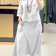 White two-piece outfit: long-sleeve tunic and gathered midi skirt with pockets