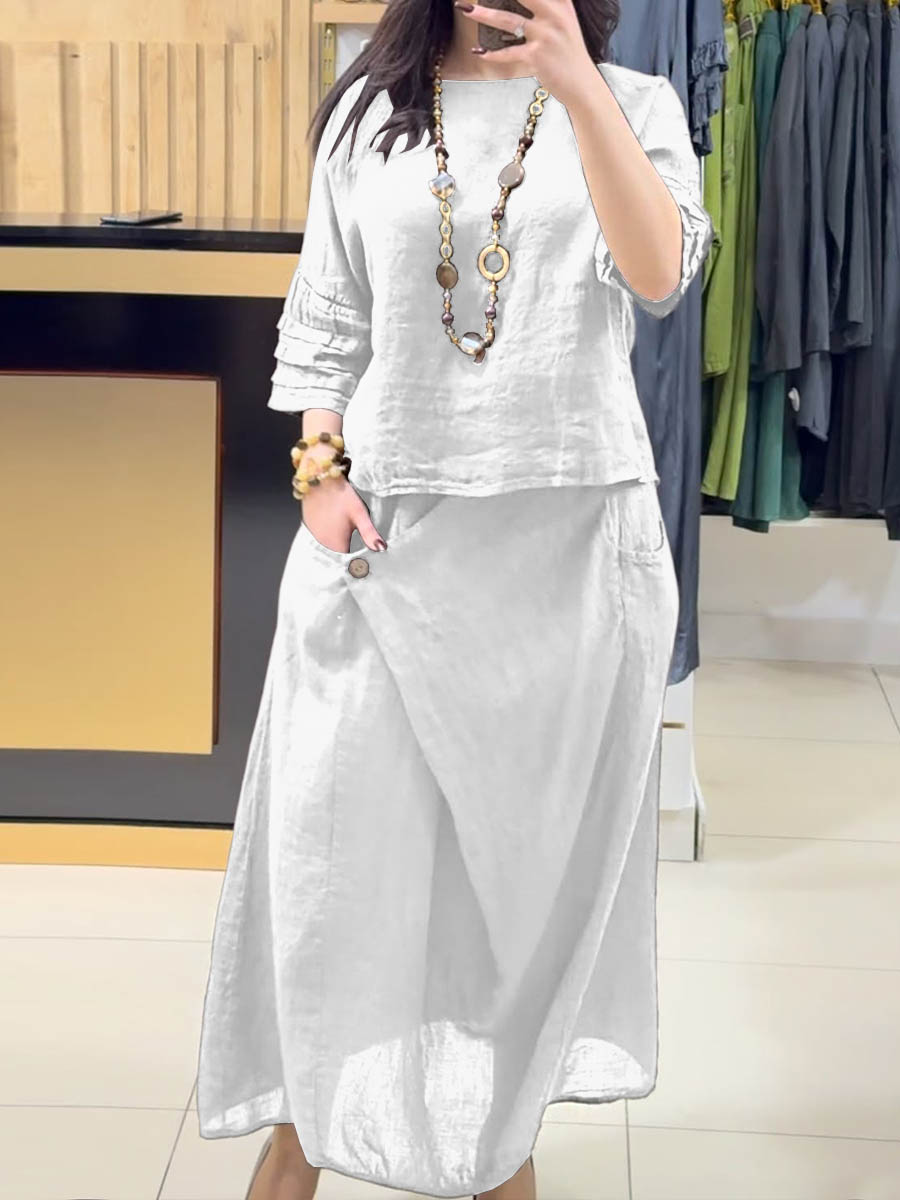 White two-piece outfit: long-sleeve tunic and gathered midi skirt with pockets
