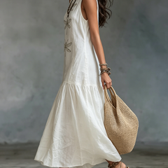 White sleeveless maxi dress with dragonfly embroidery and flowing tiered skirt