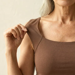 Brown built-in comfort bra tank top close-up at scoop neckline and shoulder seam