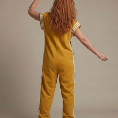 Mustard yellow back view zip-front jumpsuit with white stripe sleeves and side stripes
