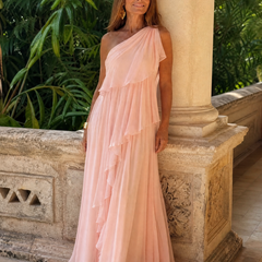 Pink one-shoulder maxi dress with tiered ruffle layers and sheer chiffon drape