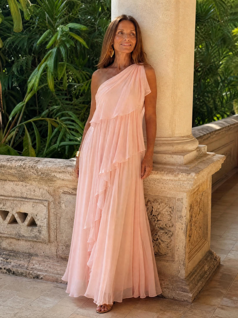 Pink one-shoulder maxi dress with tiered ruffle layers and sheer chiffon drape