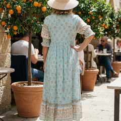 Light blue boho tiered midi dress from the back with floral print