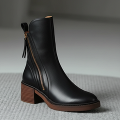 Black leather ankle boots with side zipper and tassel pull, medium block heel.