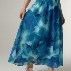 Blue tie-dye halter midi dress close-up: gathered skirt and smocked waistband