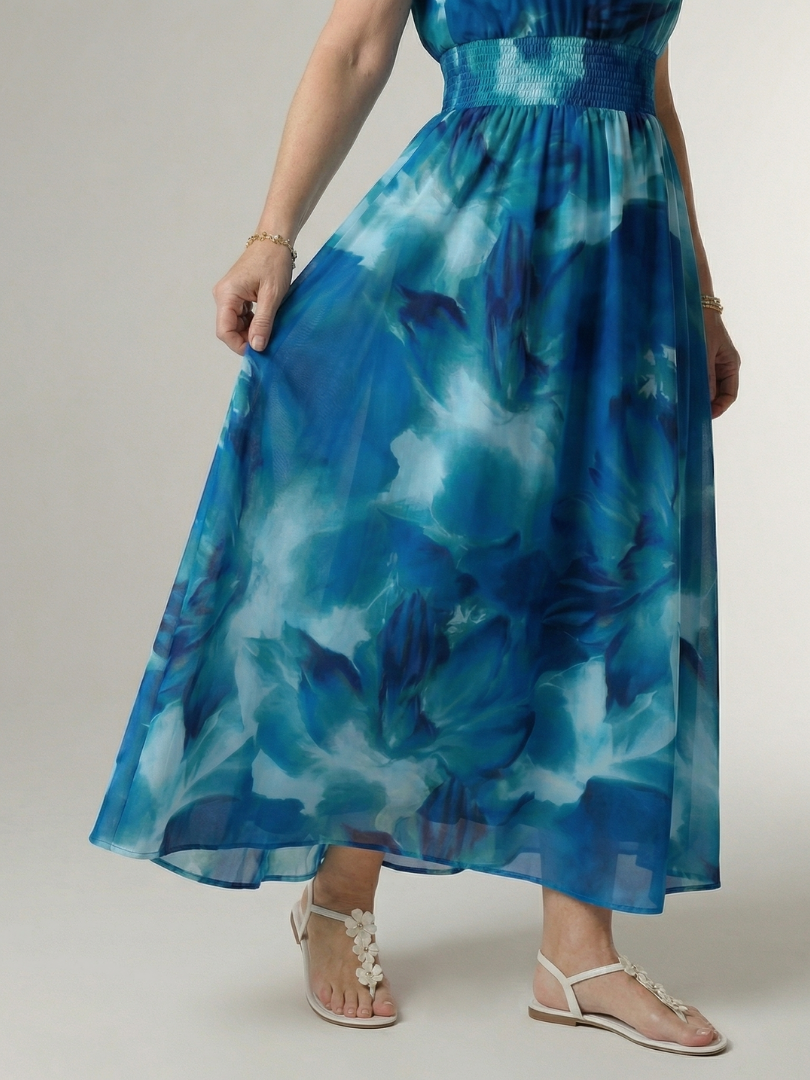Blue tie-dye halter midi dress close-up: gathered skirt and smocked waistband