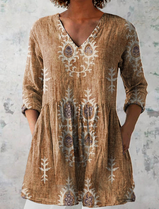 Tan long-sleeve V-neck embroidered blouse with gathered waist and folk floral details