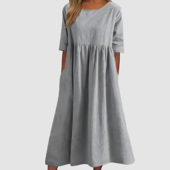 Light gray breezy dress with gathered waist and short sleeves, loose A-line midi length
