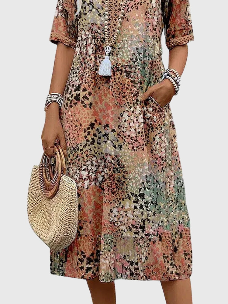 Floral midi dress with V-neck button front and white tassel, relaxed A-line fit