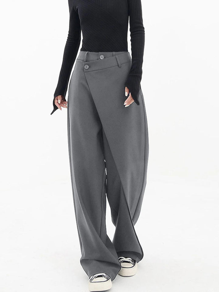 Grey baggy trousers with high waist, button front, and wide draped legs