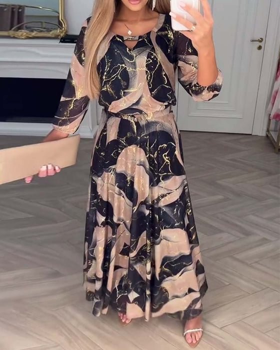 Chiffon maxi dress with dark abstract gold print, ruffled neckline, three-quarter sleeves