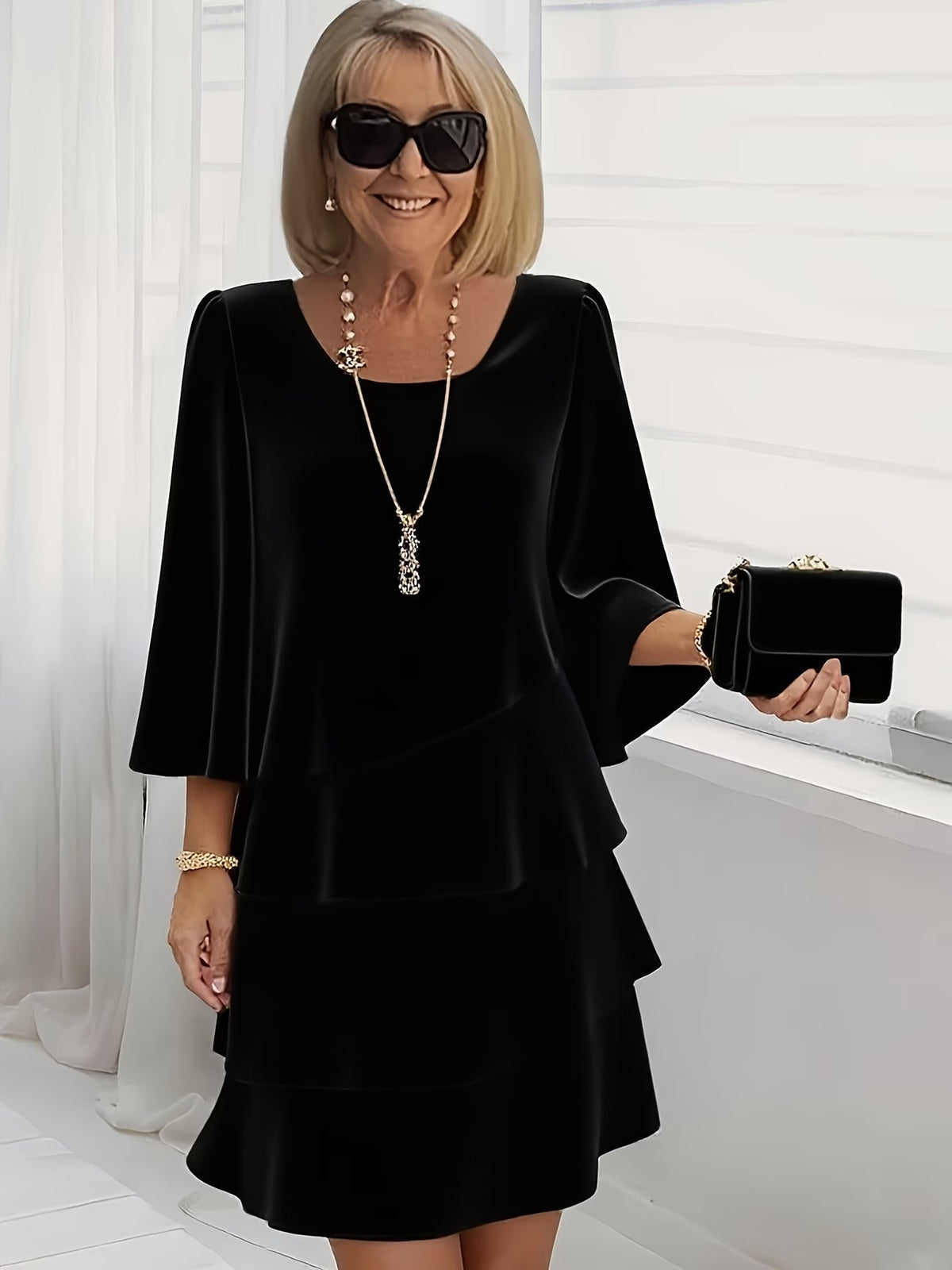 Black ruffle tiered dress with flared sleeves and square neckline