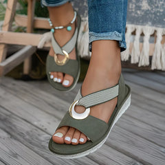 Olive flat sandals with oval metal buckle, textured strap and beaded trim