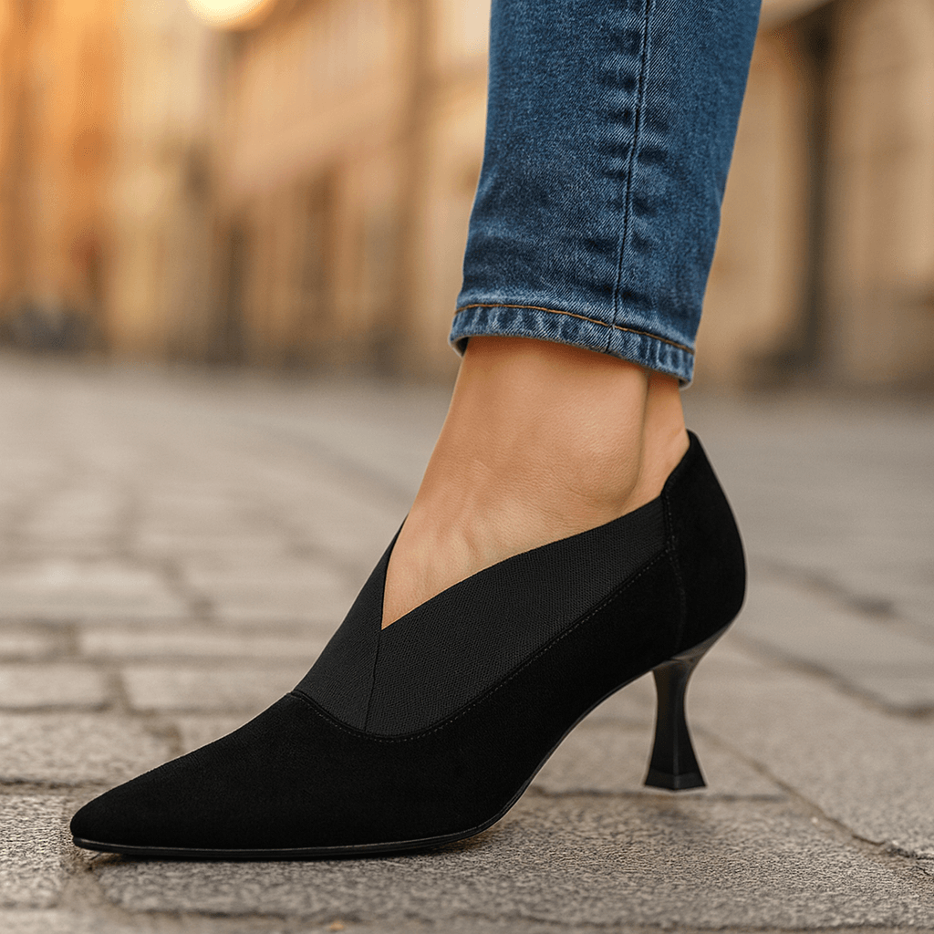Black suede pointed-toe heeled pumps with slim heel and slip-on collar
