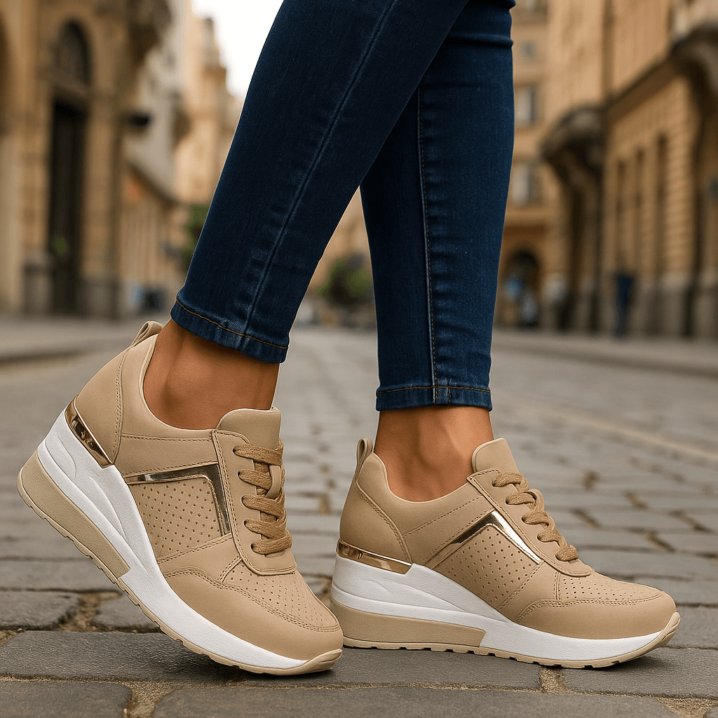 Beige lace-up sneakers with perforated toe, gold-tone heel tab, and white sole.