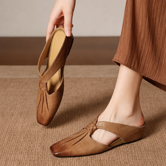 Tan square-toe genuine leather mule flats with strap and low slip-on style.