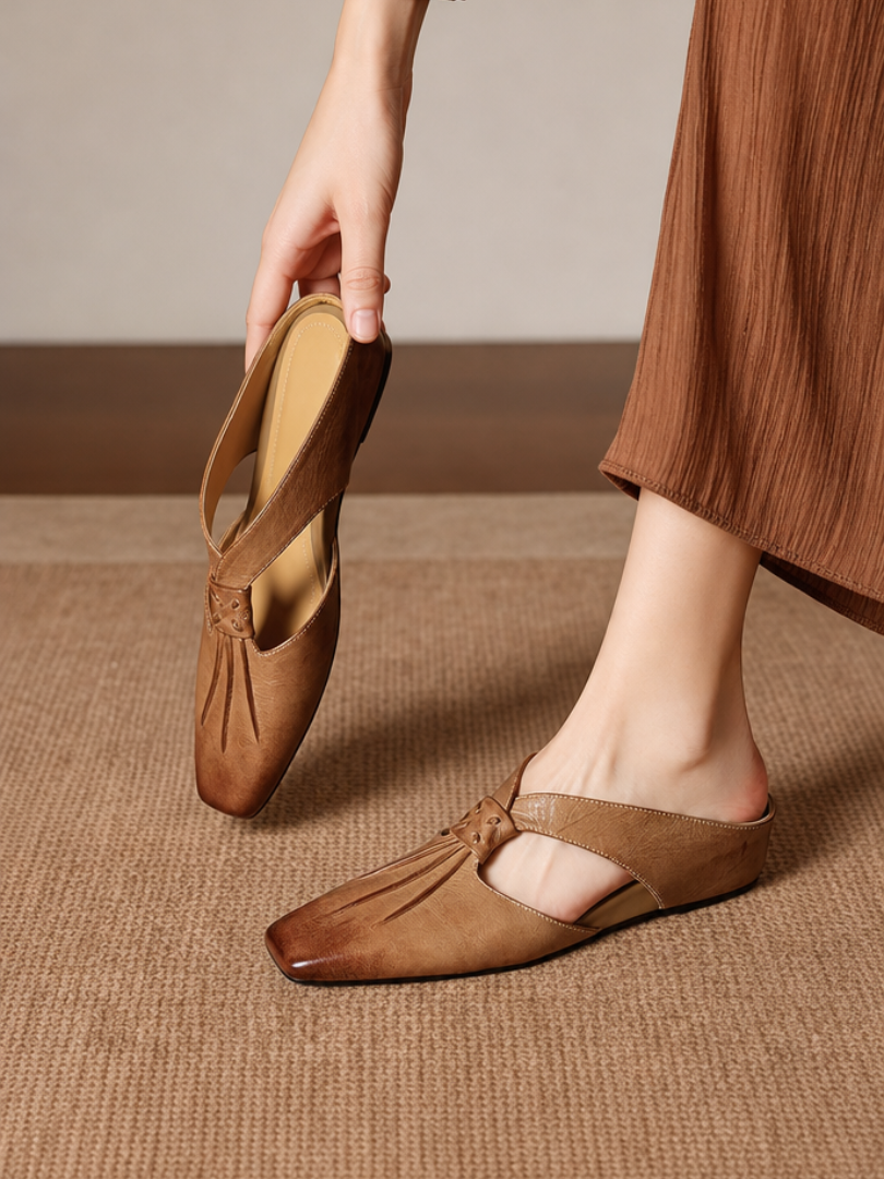 Tan square-toe genuine leather mule flats with strap and low slip-on style.