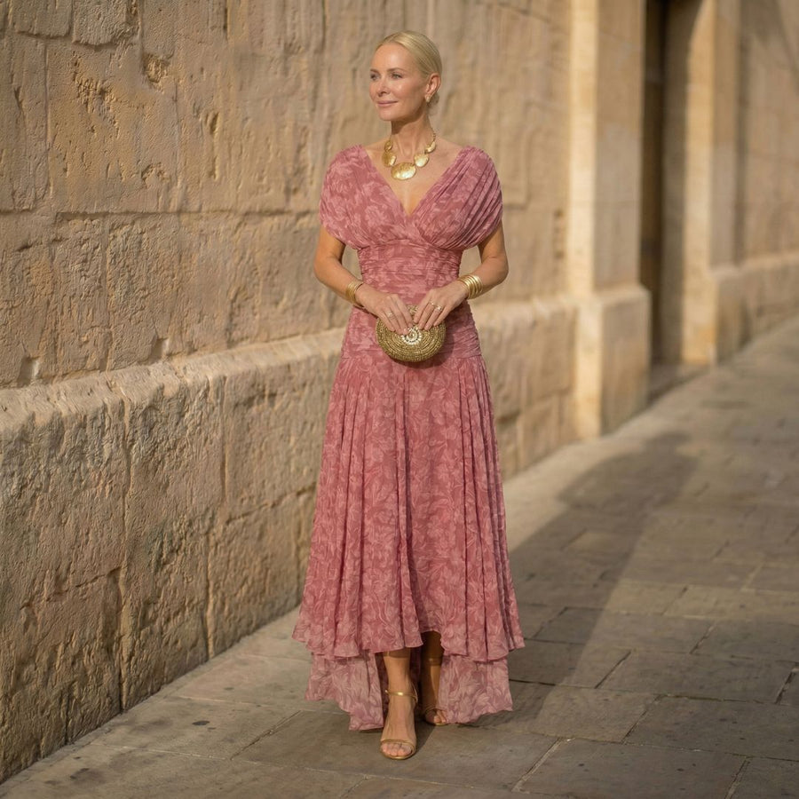 Pink V-neck flowing dress with short sleeves and layered skirt