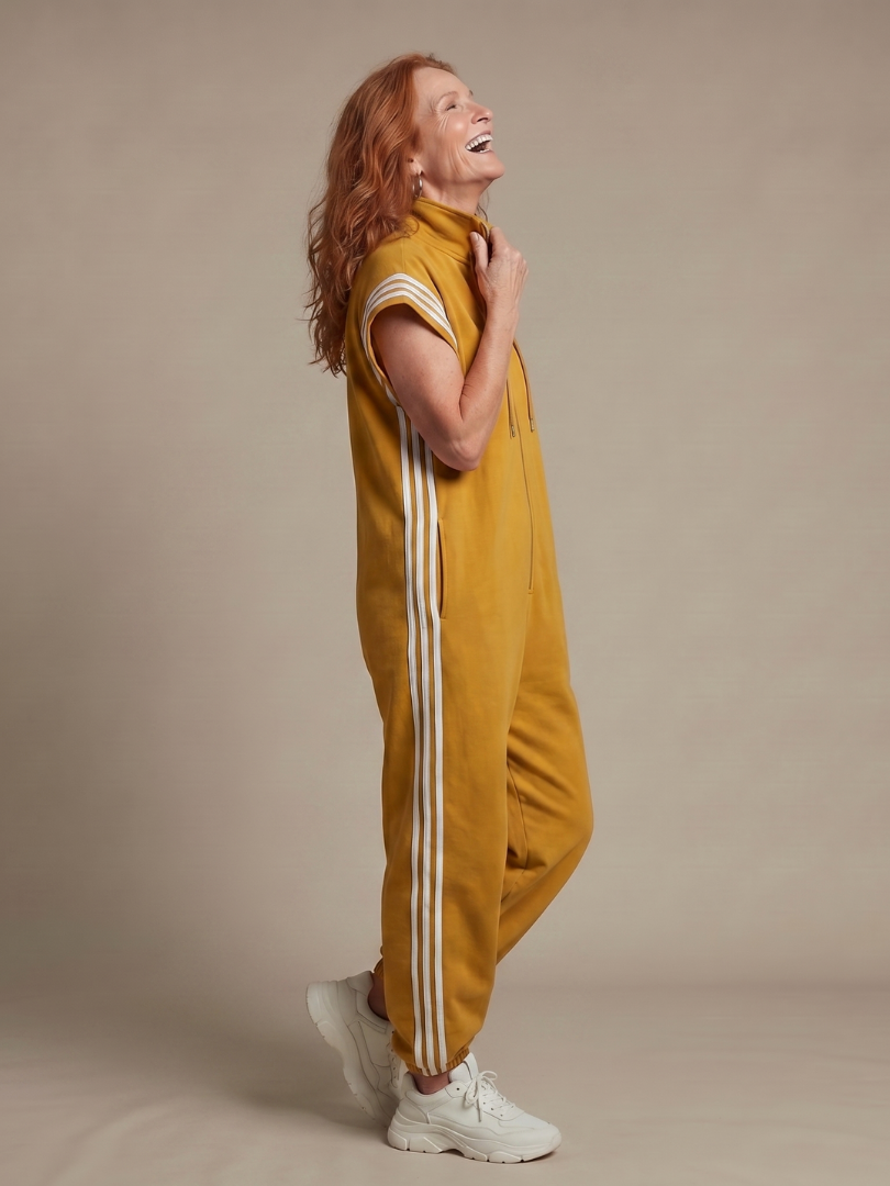 Mustard yellow sleeveless zip jumpsuit with white side stripe panels and hood