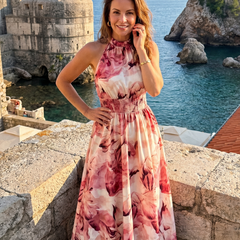 Pink/red abstract print gathered-waist midi dress with sleeveless halter neckline, full length