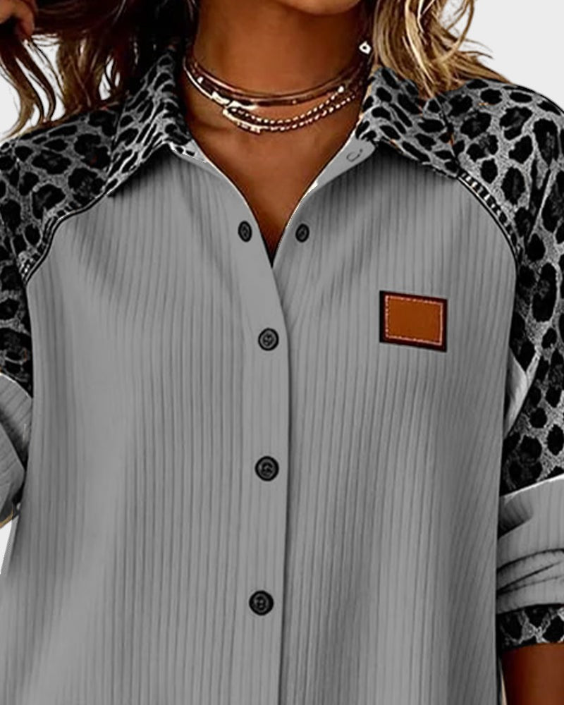 Close-up of gray striped button-down shirt with leopard-print yoke and square chest patch