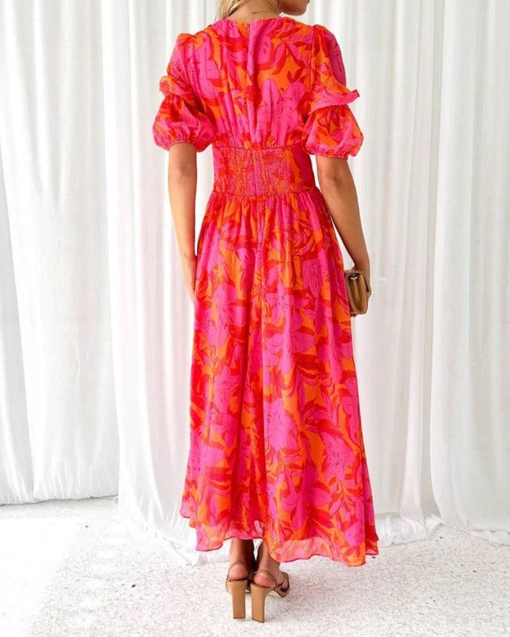 Back view of long maxi dress with ruched waist and flutter ruffled sleeves, pink print