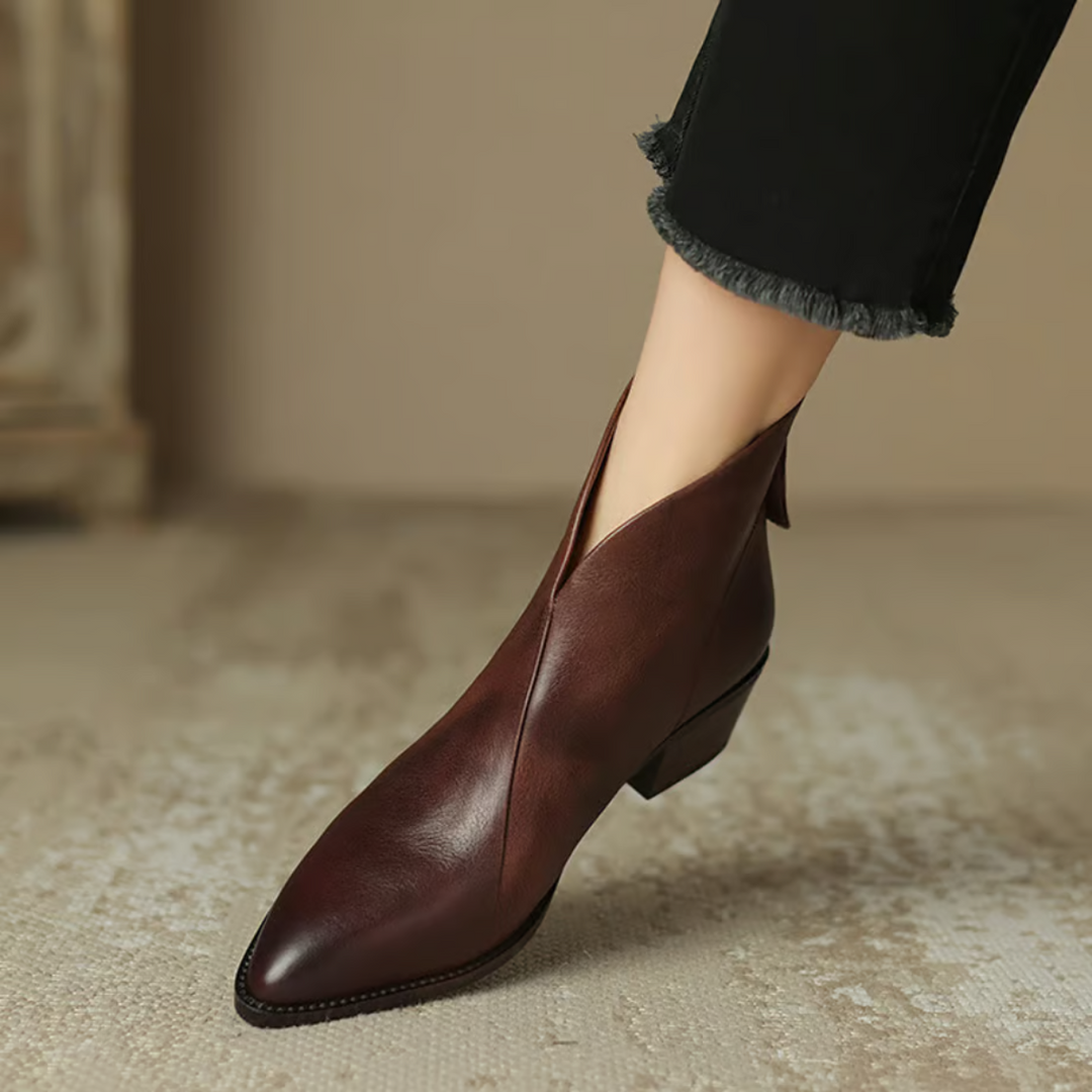 Brown leather ankle boots with pointed toe, side zipper opening, and sculpted heel